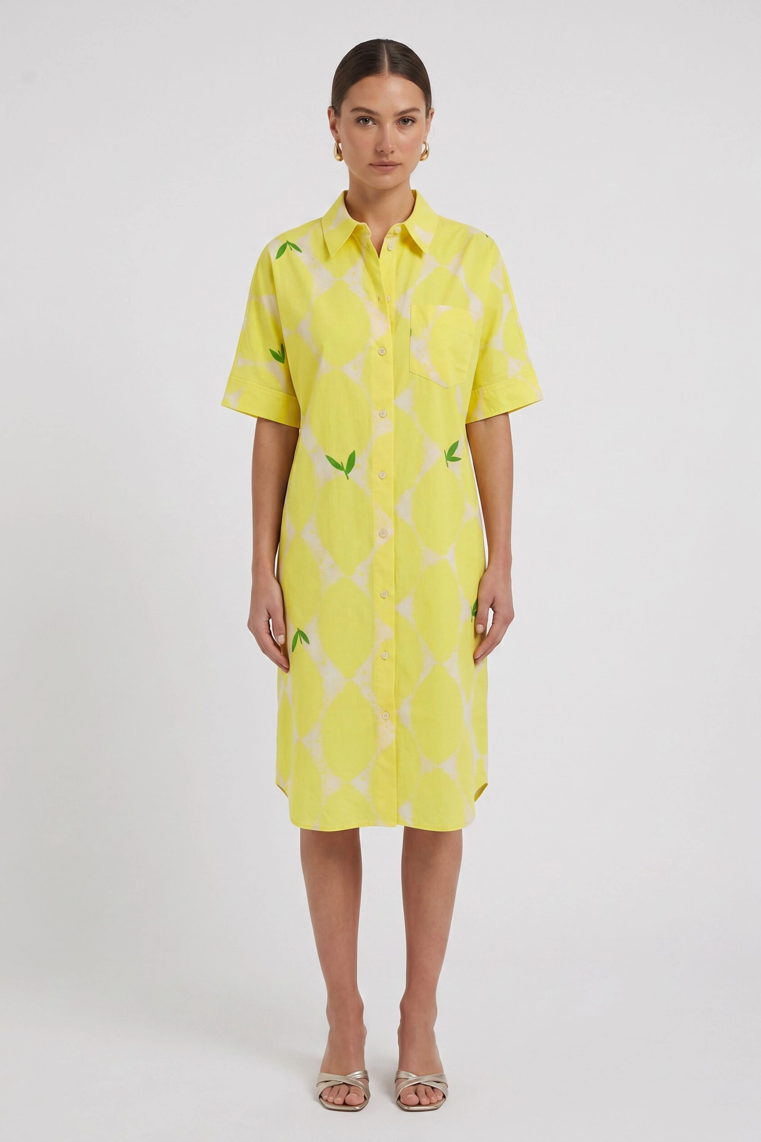 Gelbes Hemdblusenkleid mit Zitronenmuster, kurzärmelig und knielang, ohne Model abgebildet.