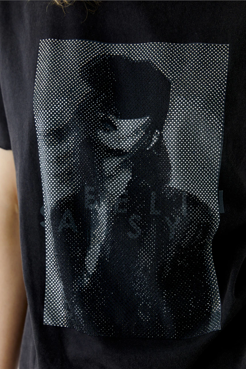 Graphic T-shirt: Woman in a black T-shirt with a bold graphic print, showcasing modern style.