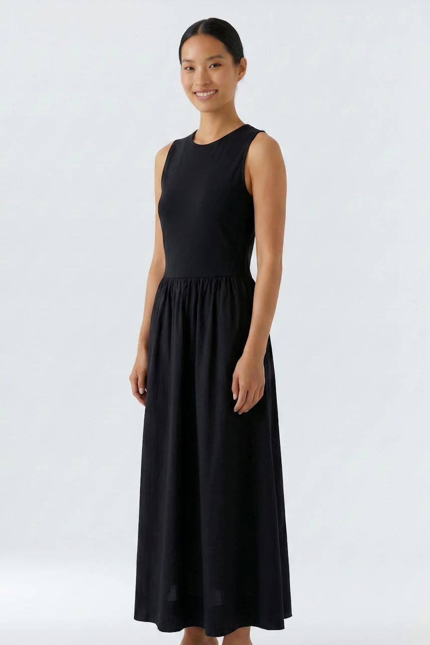 Casual midi dress: Woman in a sleeveless black midi dress, smiling confidently.