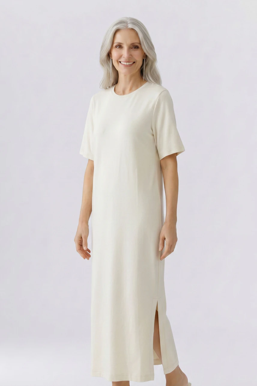 Casual dress: Woman in a cream-colored, short-sleeve dress with side slit, smiling confidently.
