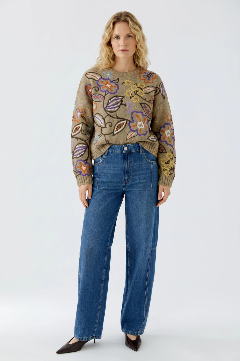 Colorful floral pullover: Beige knit with vibrant flower patterns, perfect for a casual look.