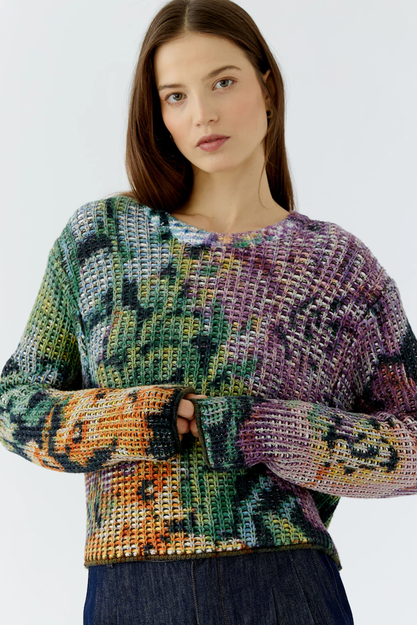 Colorful pullover: Woman in a vibrant knit pullover with a relaxed fit, showcasing a casual style.