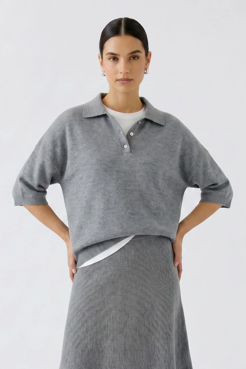 Casual women's pullover: Woman in a grey pullover with a collared neckline and relaxed fit.