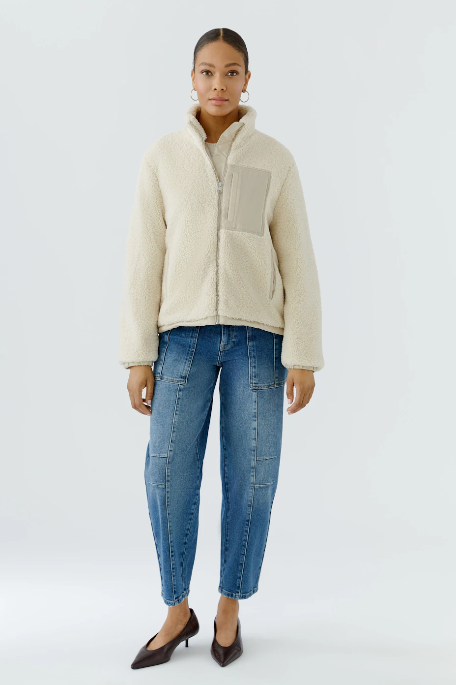 Cozy women's blouson: Cream fleece blouson with high collar and beige pocket detail, perfect for casual wear.