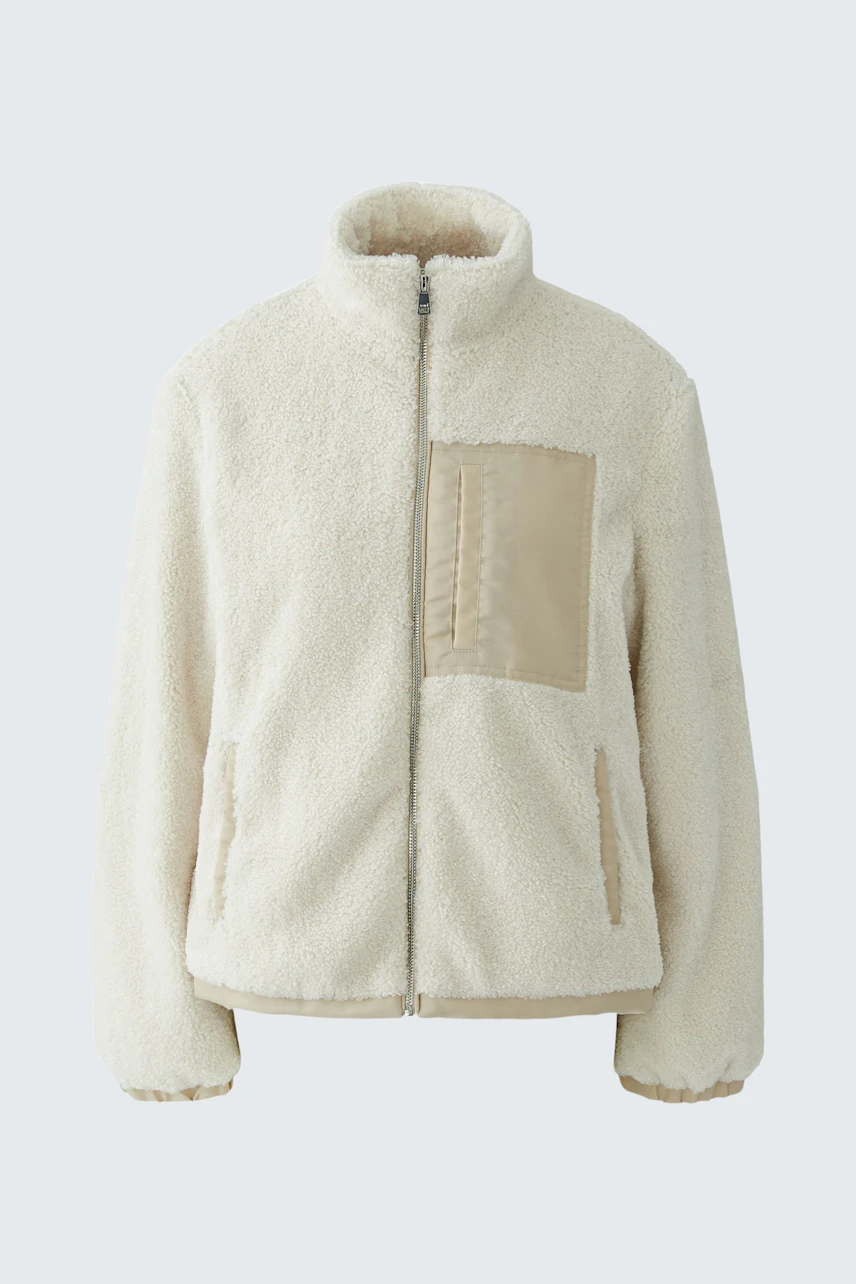 Cozy women's blouson: Cream fleece blouson with high collar and beige pocket detail, perfect for casual wear.