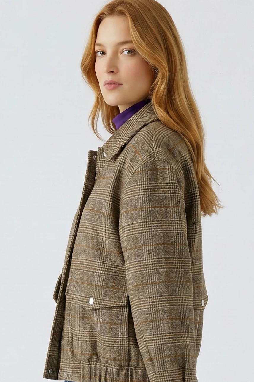 Plaid blouson: Woman in a checkered blouson with a purple shirt underneath, looking confidently to the side.