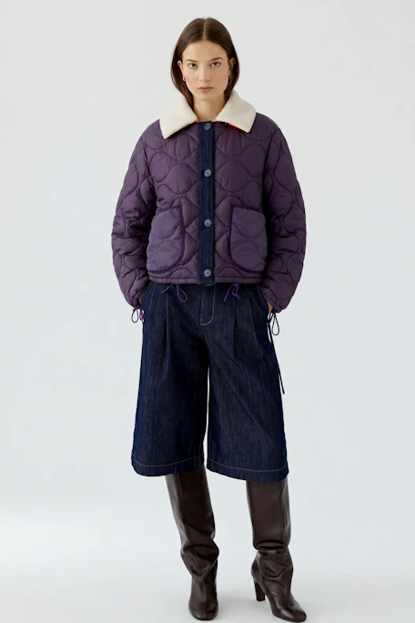 Reversible jacket: Quilted purple jacket with orange accents and a cozy white collar.