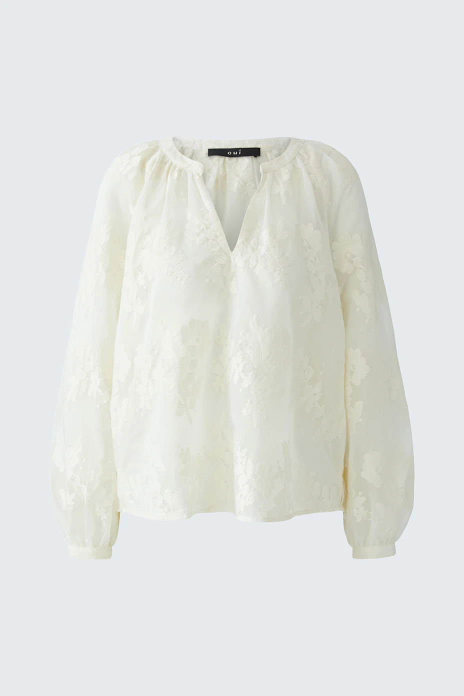 White tunic with floral texture, long sleeves, and relaxed fit. No model, just the garment.