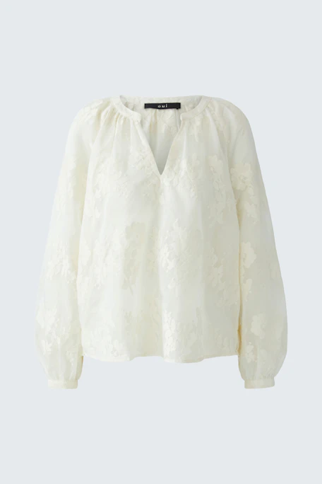 White tunic with floral texture, long sleeves, and relaxed fit. No model, just the garment.