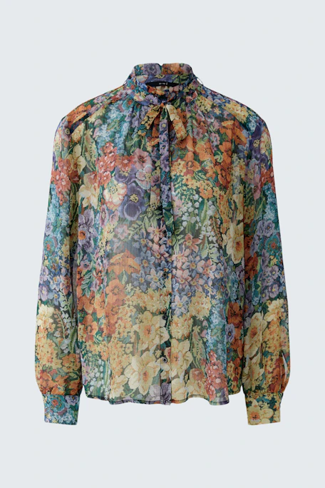 Colorful floral blouse: A vibrant, sheer blouse with a floral pattern, perfect for a lively look.