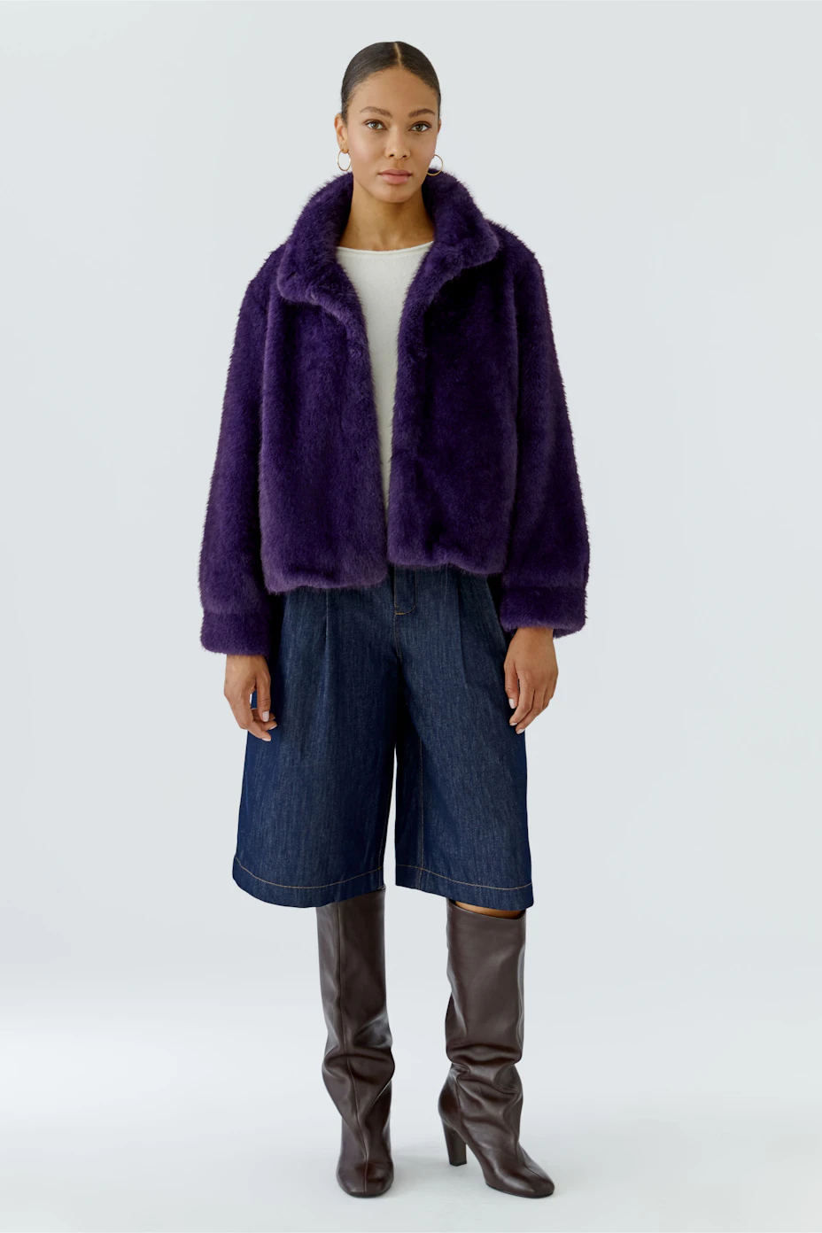 Plush outdoor jacket in deep purple, perfect for warmth and style. No model, just the jacket displayed.