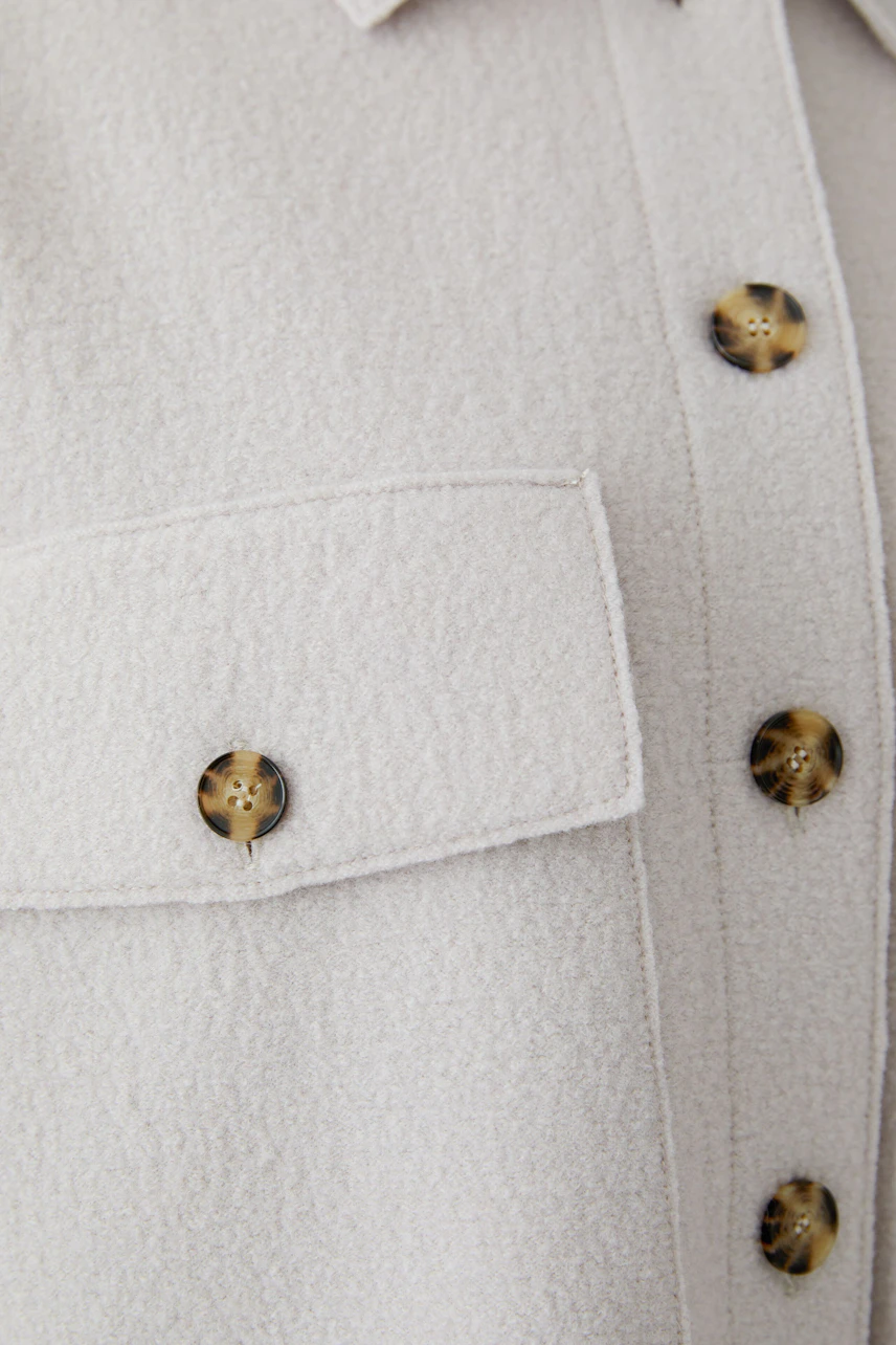 Textured overshirt with tortoiseshell buttons, showcasing a casual and versatile style.
