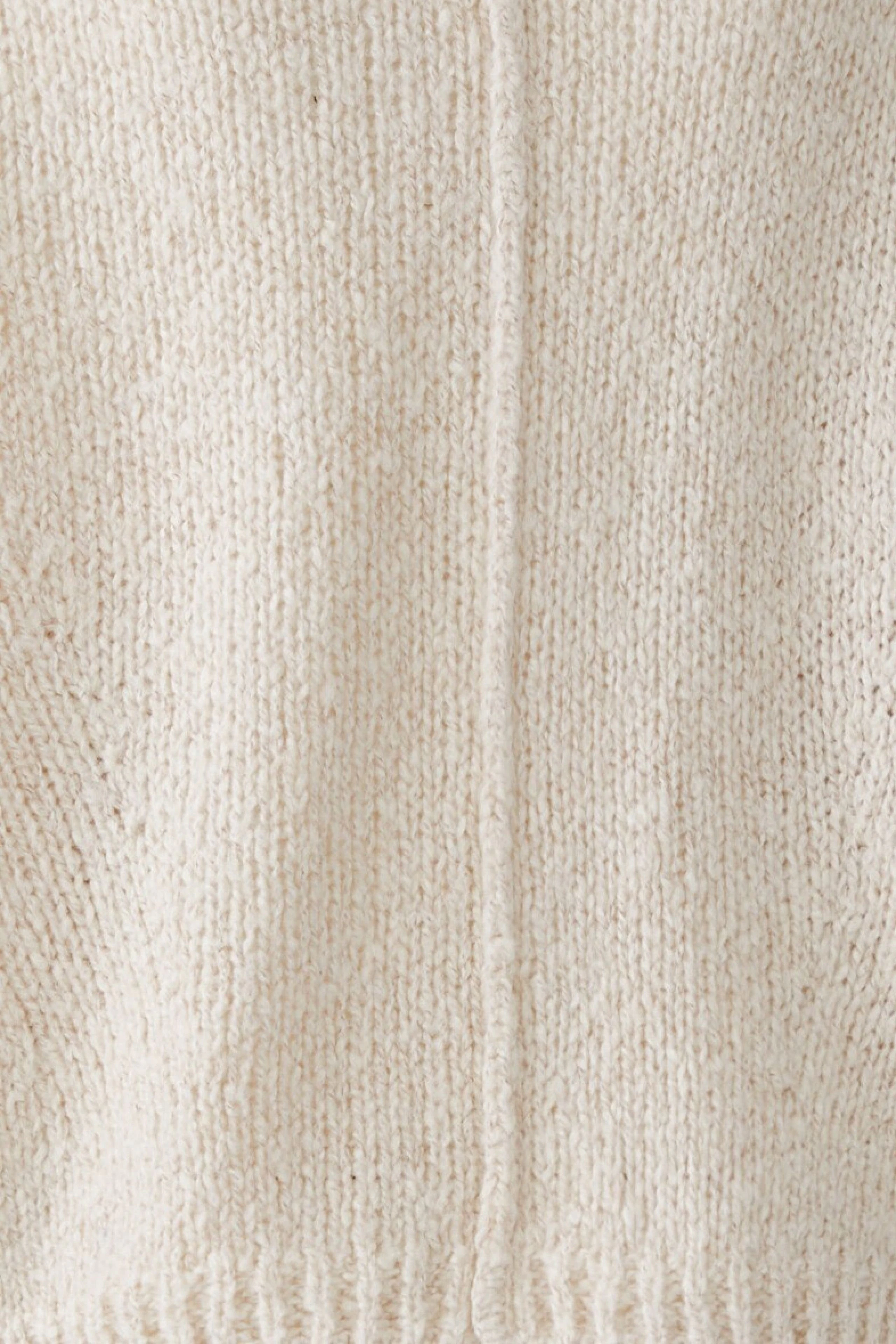 Cozy women's pullover in soft cream knit, perfect for casual comfort and style.