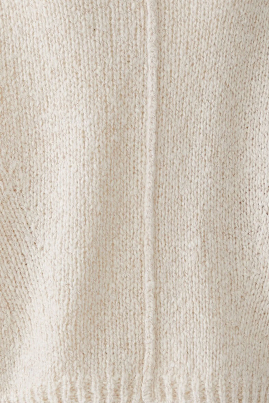 Cozy women's pullover in soft cream knit, perfect for casual comfort and style.