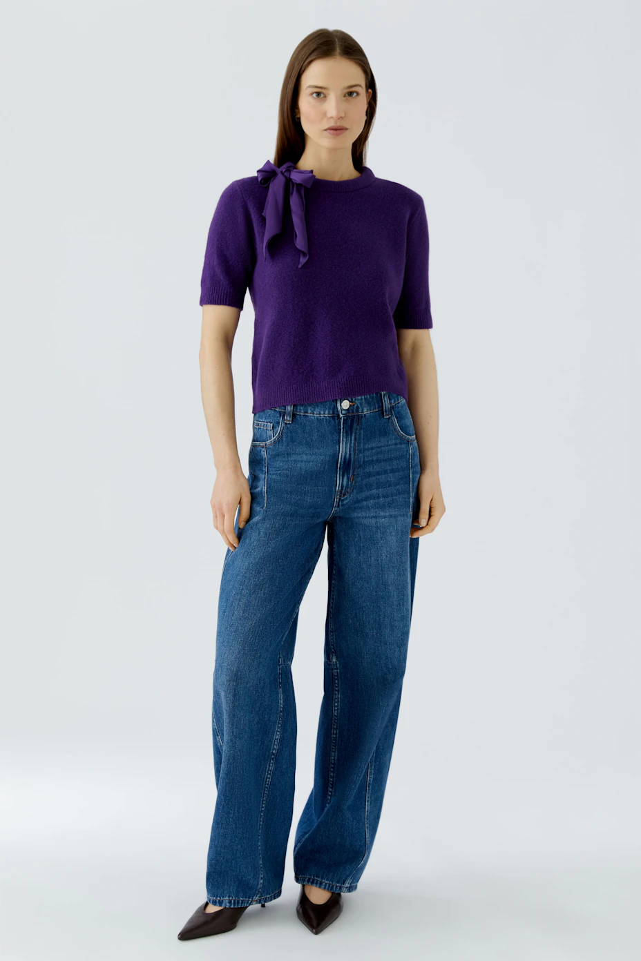 Purple pullover with short sleeves and a stylish bow detail on the shoulder.