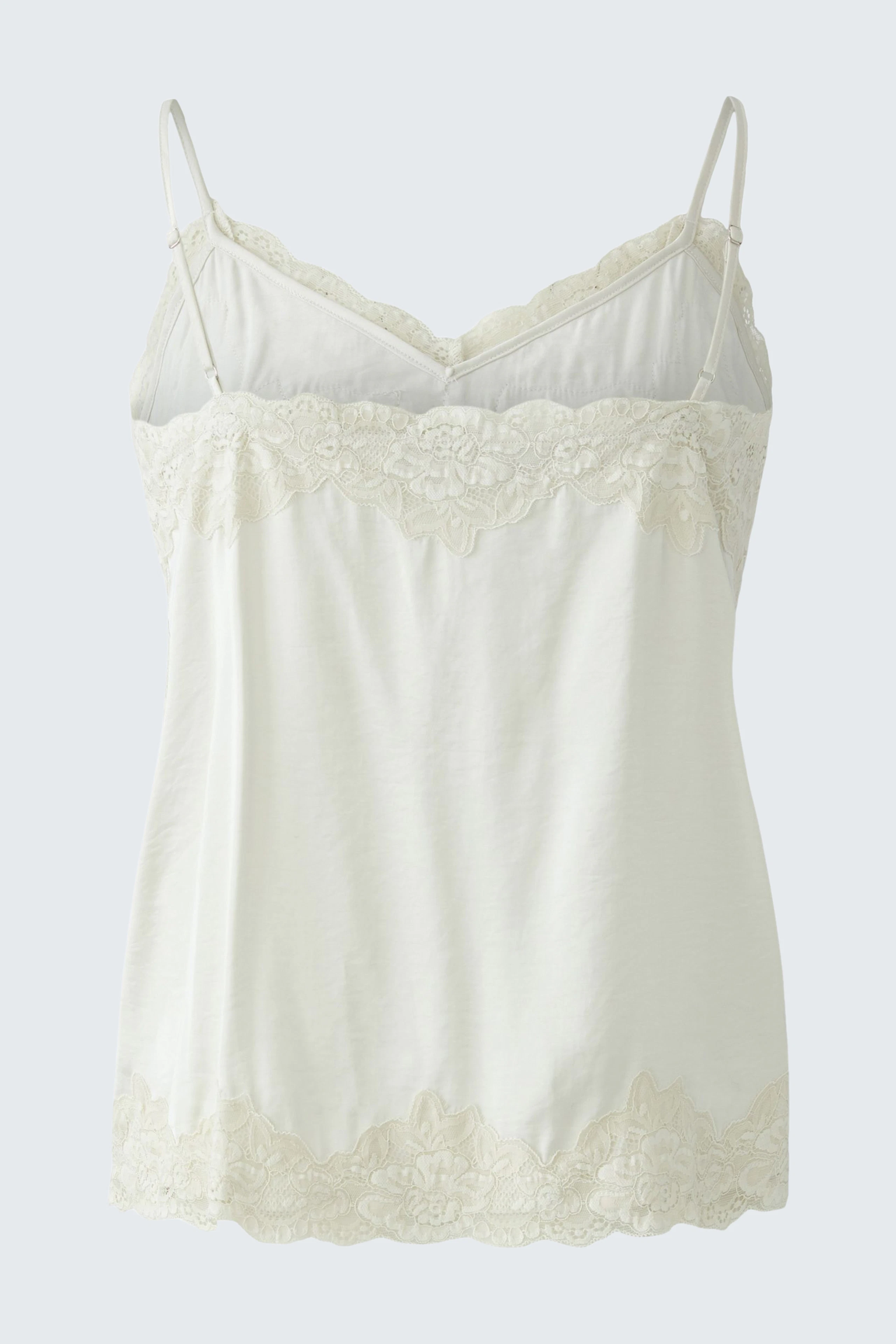 Women's top: White lace-trimmed top with thin straps, perfect for layering or wearing alone.