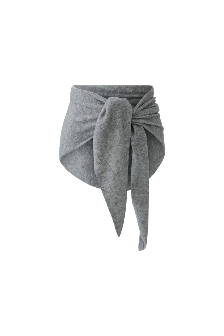 Soft grey scarf with a stylish knot, perfect for adding warmth and texture to any outfit.