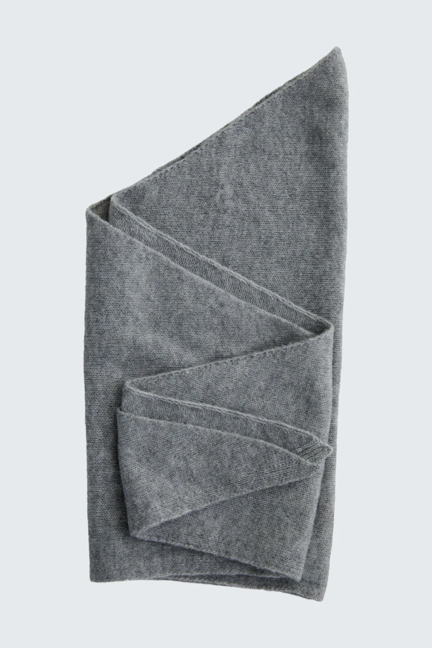 Soft grey scarf folded neatly, showcasing its texture and versatile style.