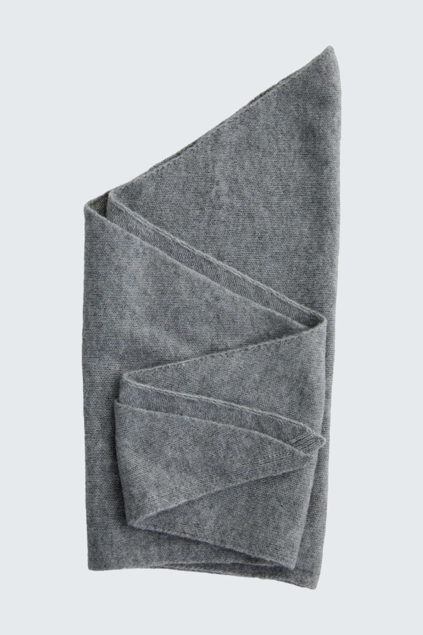 Soft grey scarf folded neatly, showcasing its texture and versatile style.