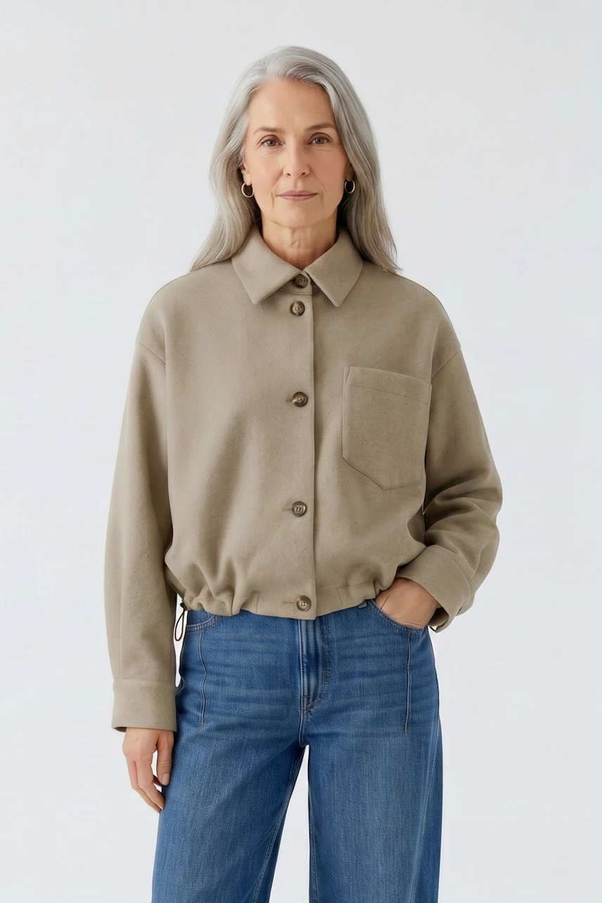 Damen-Jacke: Frau in beiger Jacke mit Knopfleiste und Brusttasche, kombiniert mit blauer Jeans.