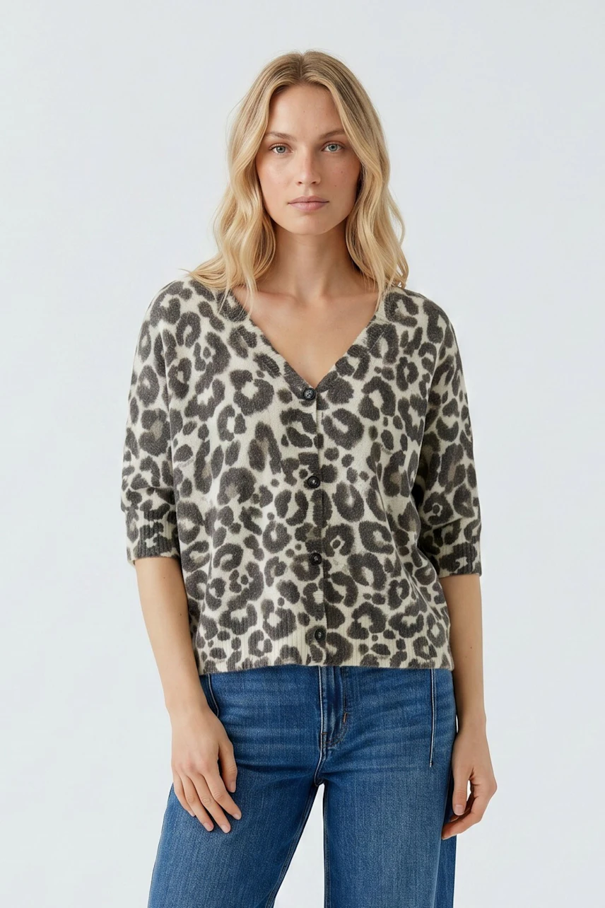Casual cardigan: Woman in leopard print cardigan with blue jeans, exuding a relaxed vibe.