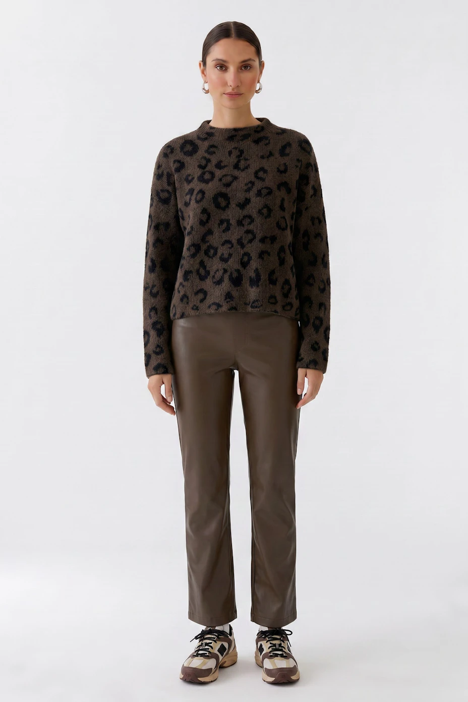 Brown faux leather pants with a quilted waistband, displayed without a model.