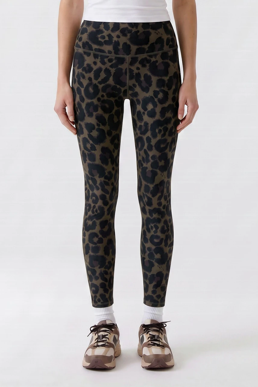 Leopard print leggings: Woman in stylish, high-waisted leggings paired with sneakers and a white top.