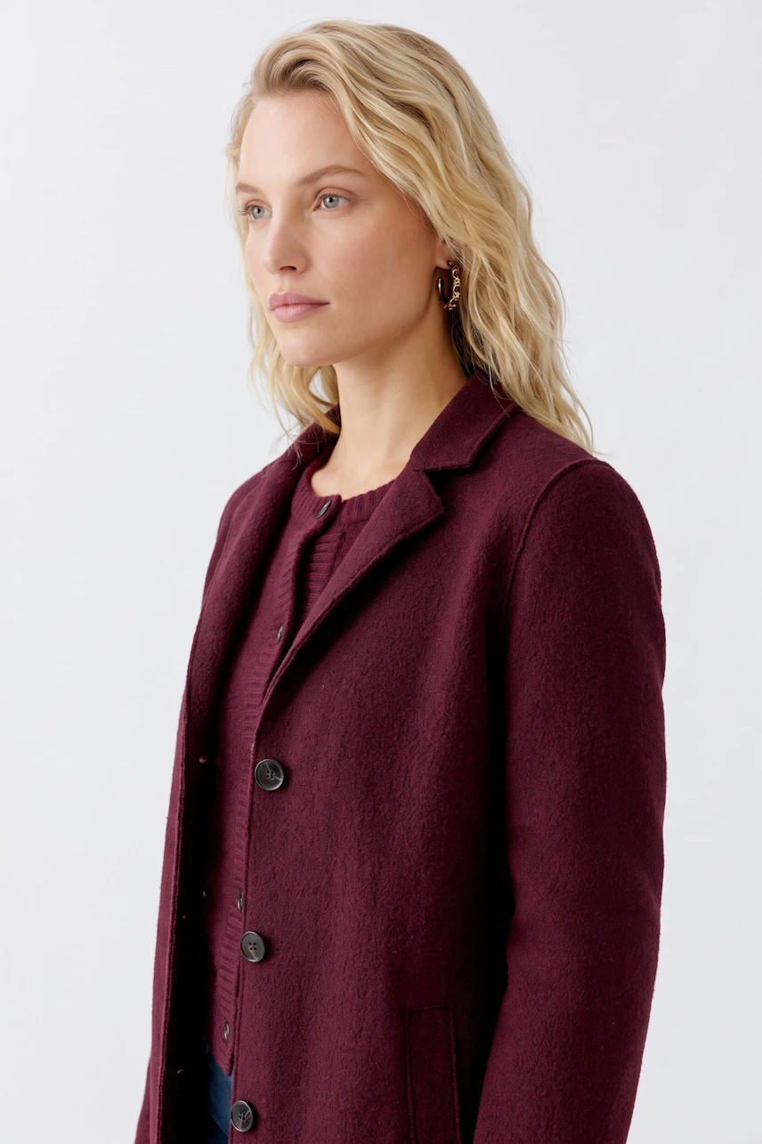 Stylish women's wool coat in deep burgundy, featuring a classic collar and button closure.