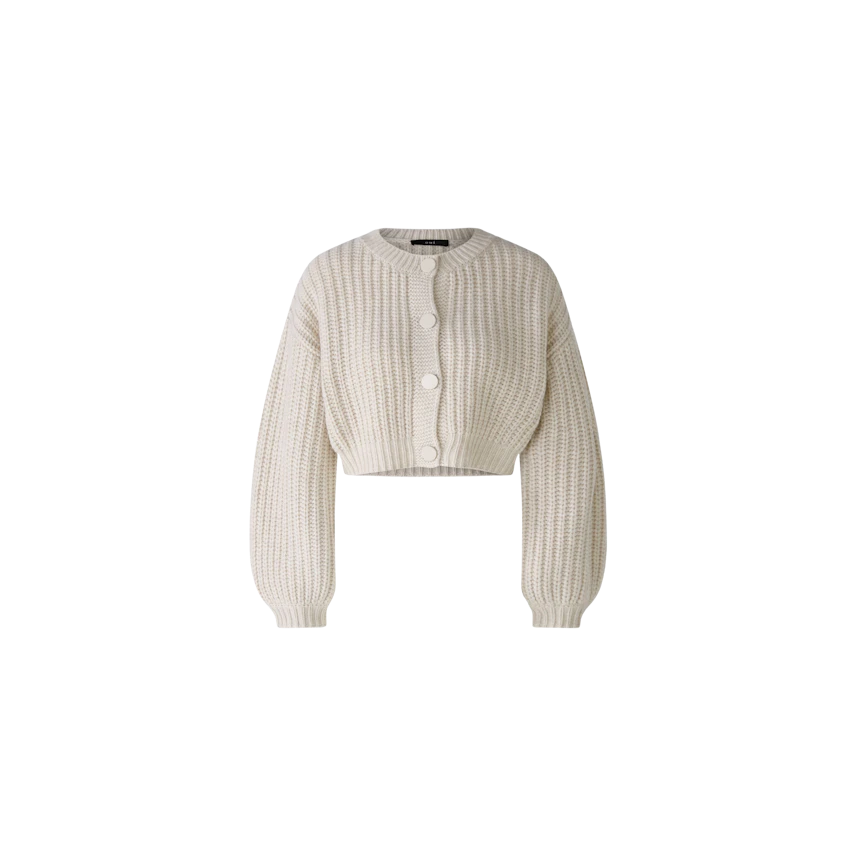 Stylish women's cardigan: A woman in a cream cropped cardigan with buttons, perfect for layering.