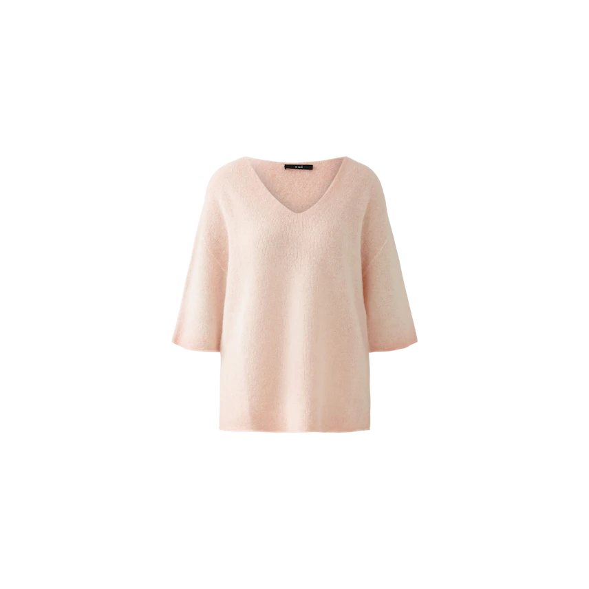 Soft pink pullover with a V-neck and wide sleeves, perfect for a casual yet stylish look.