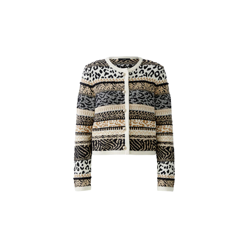 Stylish women's cardigan: A woman in a patterned black and cream cardigan with animal prints.