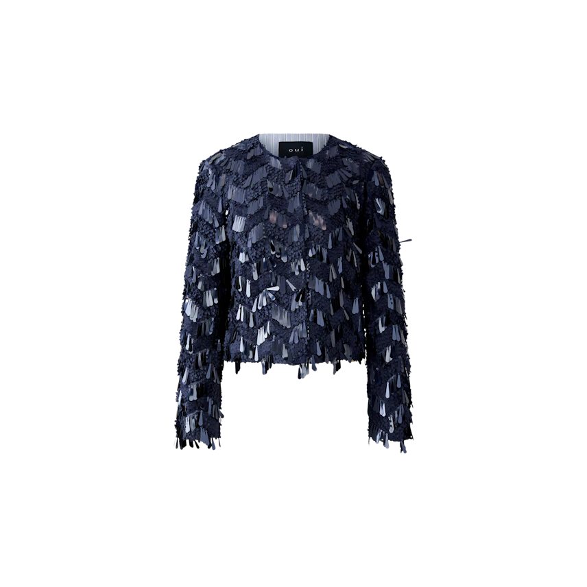 Stylish women's jacket: A woman in a navy jacket with fringes, perfect for casual outings.
