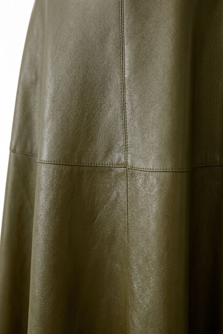 A-line skirt in olive green leather, showcasing smooth texture and subtle stitching details.