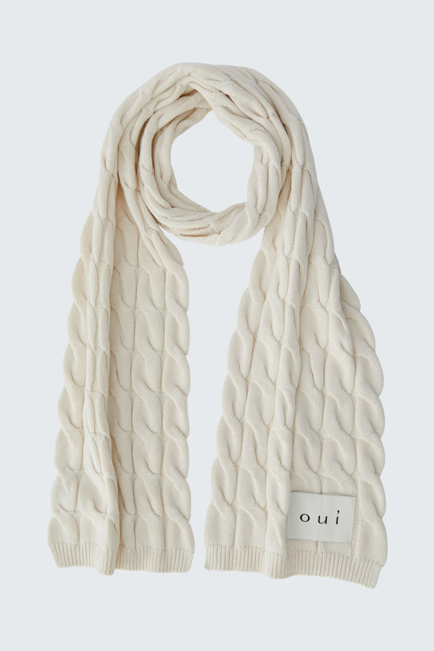 Cozy cream scarf with textured pattern, perfect for layering in cooler weather. Soft and stylish accessory.