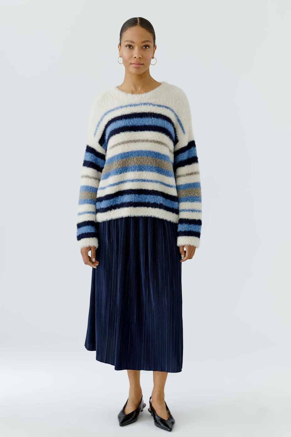 Striped pullover in blue and white hues, featuring a cozy, textured knit. No model, just the garment.