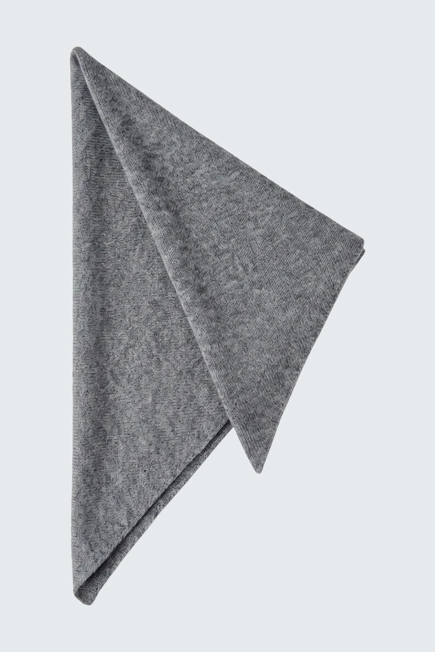 Soft grey scarf folded neatly, showcasing its texture and versatile style.