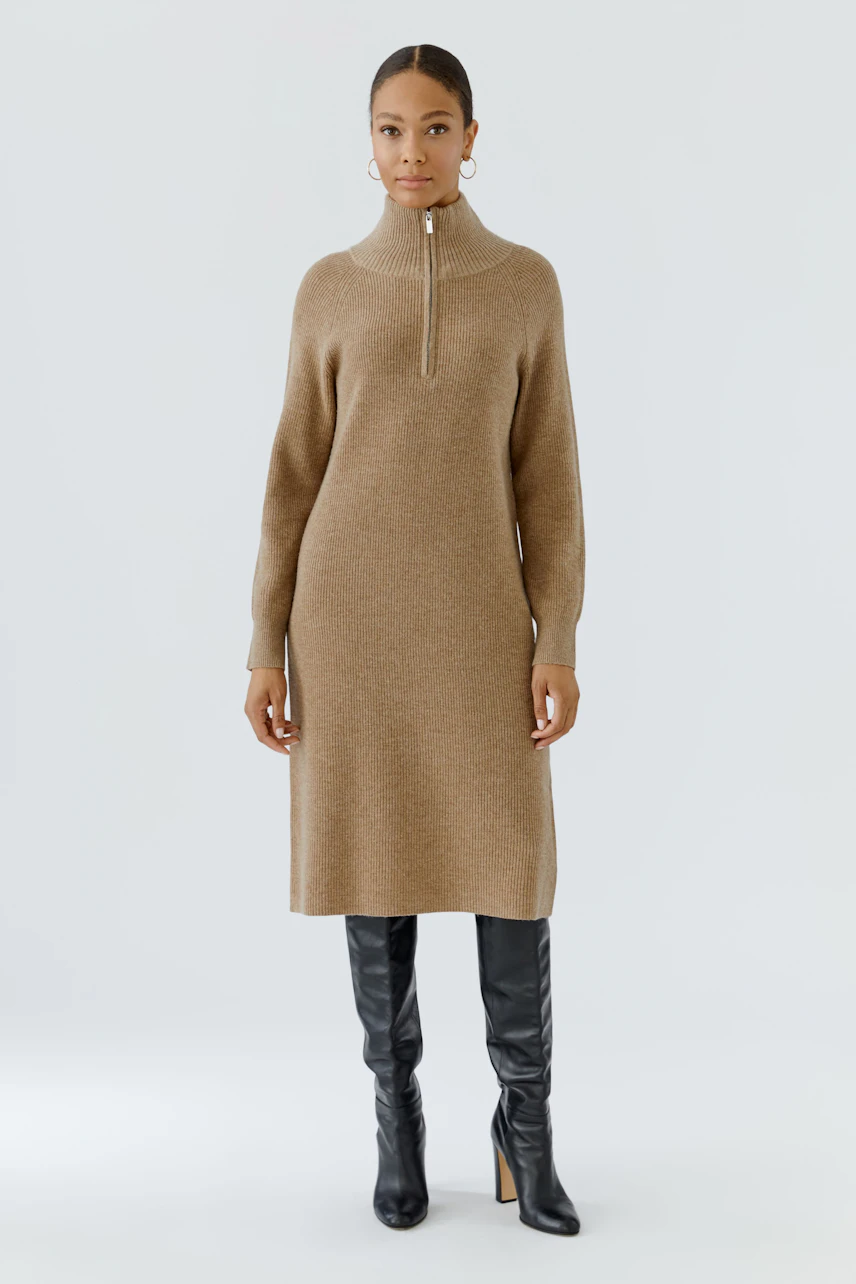Knit dress: Woman in a brown knit dress with a high collar and black knee-high boots.