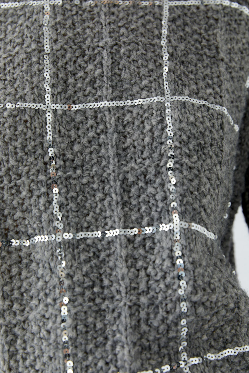Textured grey pullover with sequin grid pattern, showcasing a stylish and modern design.