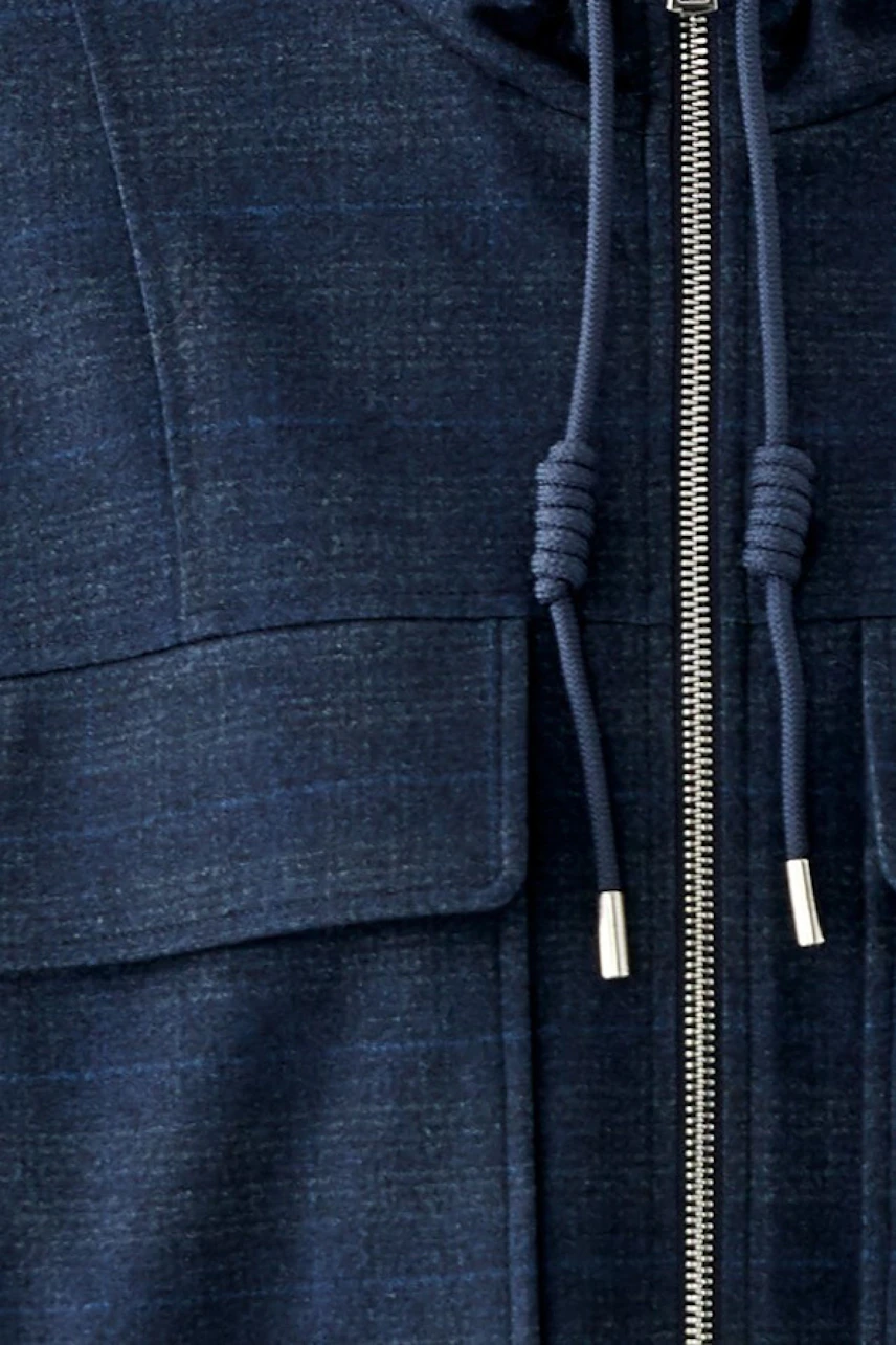 Casual women's jacket: Close-up of a navy blue jacket with a zipper and drawstrings.