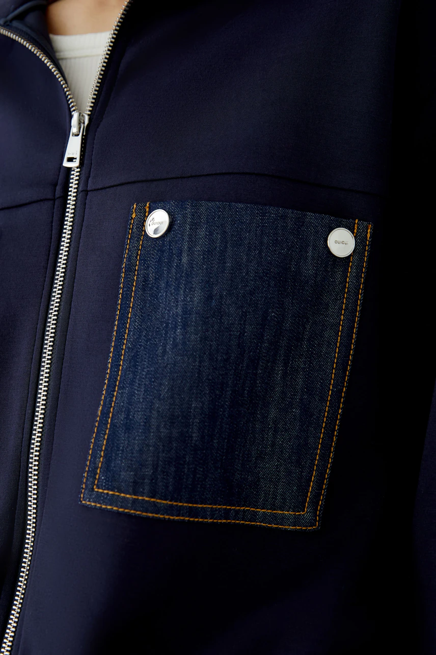 Casual blouson with denim pocket detail, perfect for a relaxed look. No model, just the garment shown.