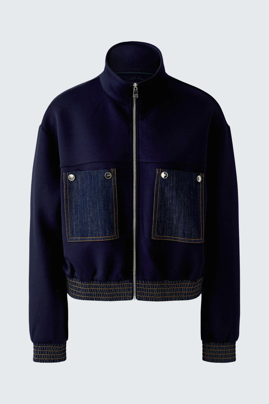 Navy blouson with denim pockets, zip closure, and ribbed cuffs. Casual and versatile for everyday wear.