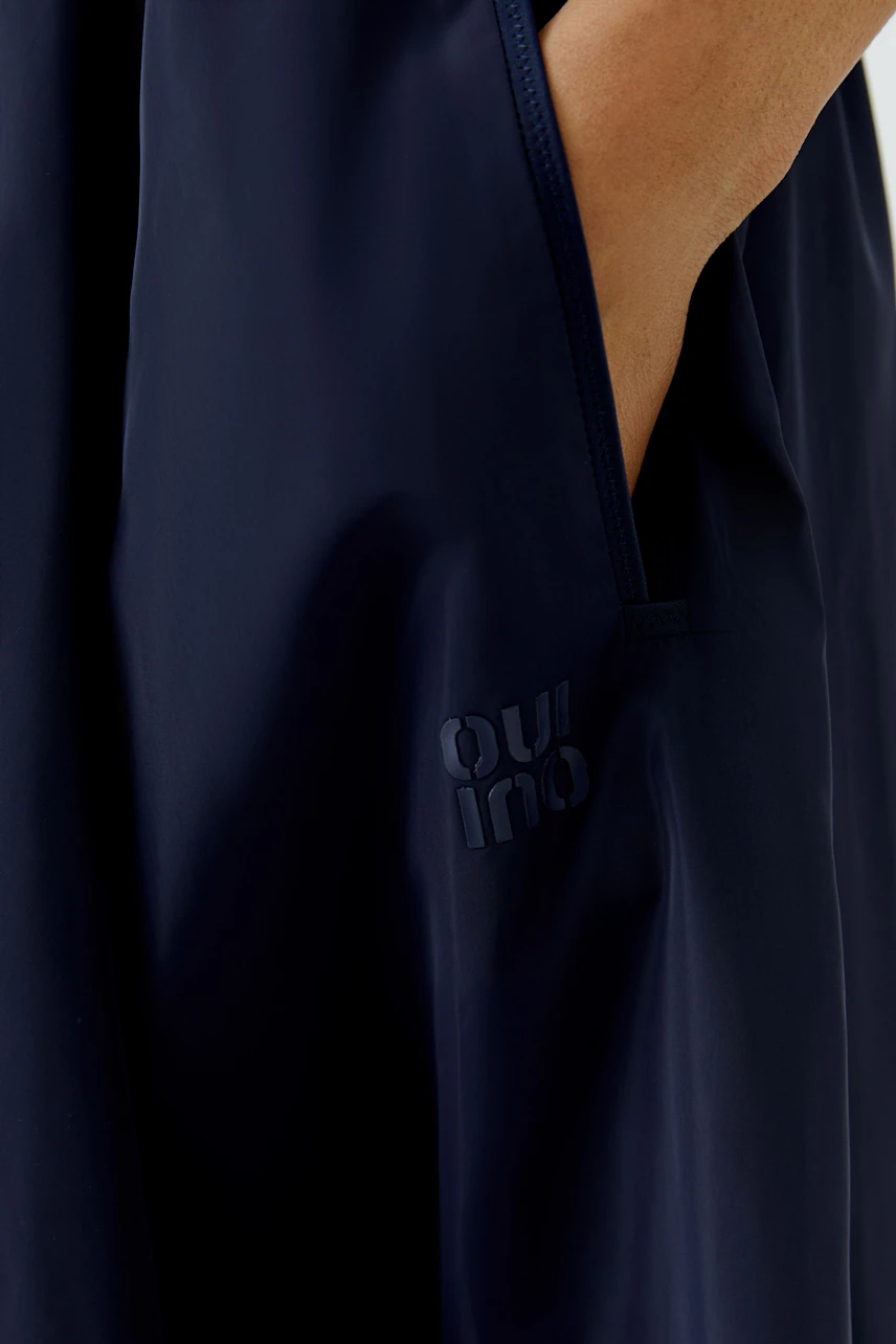 Navy midi skirt with side pocket detail, featuring subtle 'Oui' branding. Casual and versatile for daily wear.