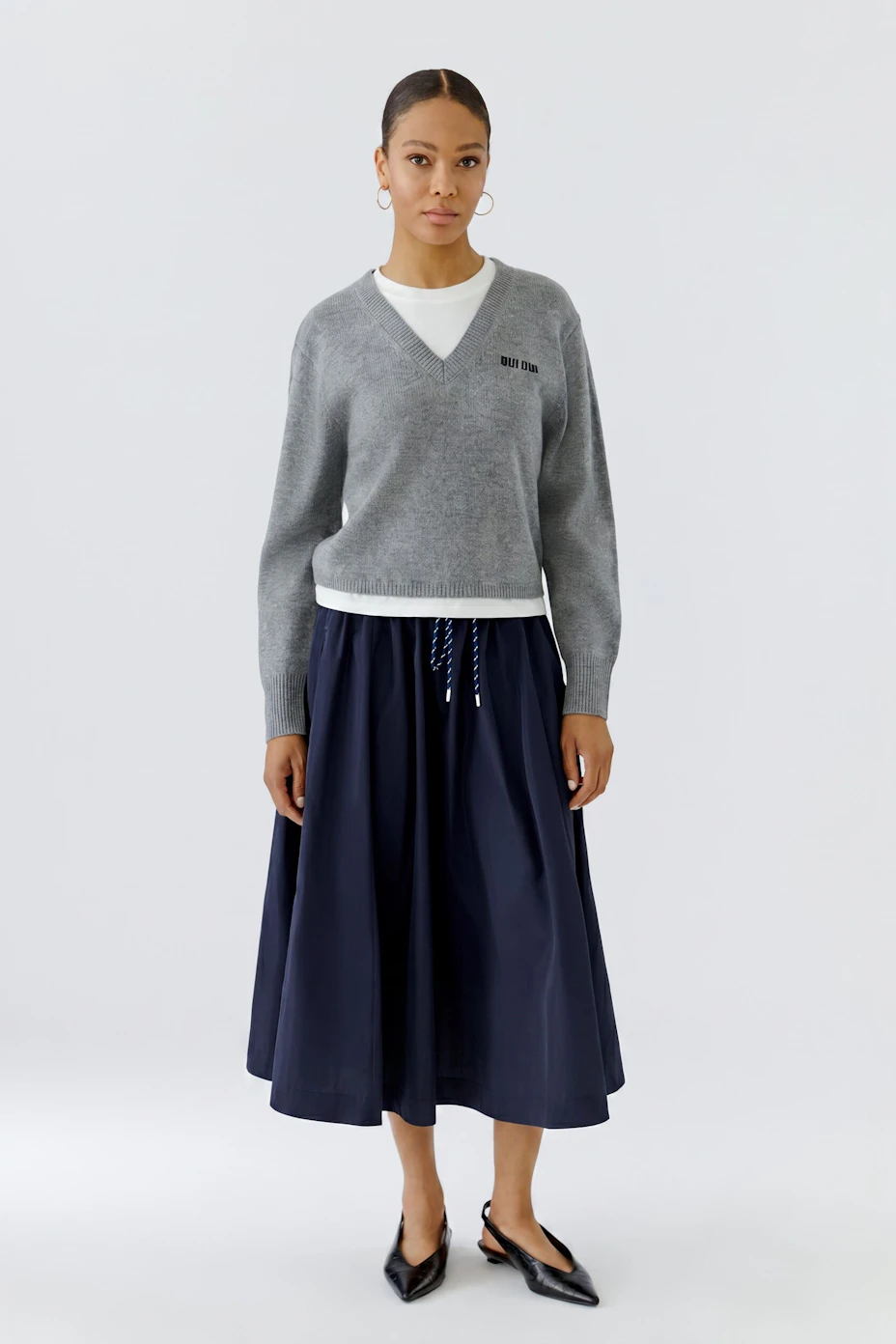 Navy blue midi skirt with drawstring waist, perfect for casual outings.