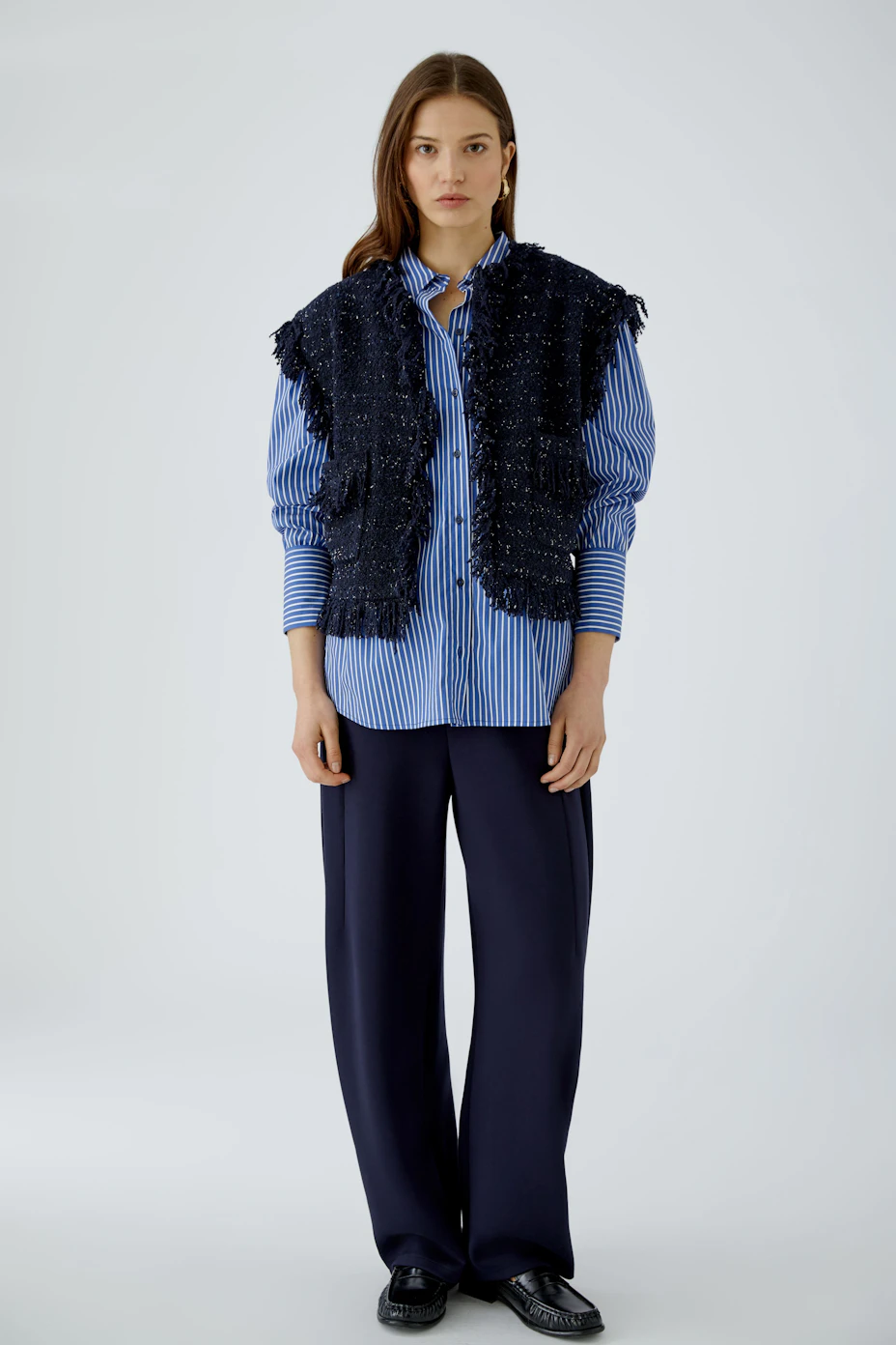 Textured women's vest: Dark blue, sleeveless with fringe details and front pockets.