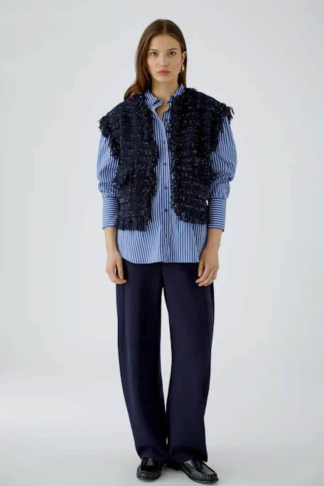 Textured women's vest: Dark blue, sleeveless with fringe details and front pockets.