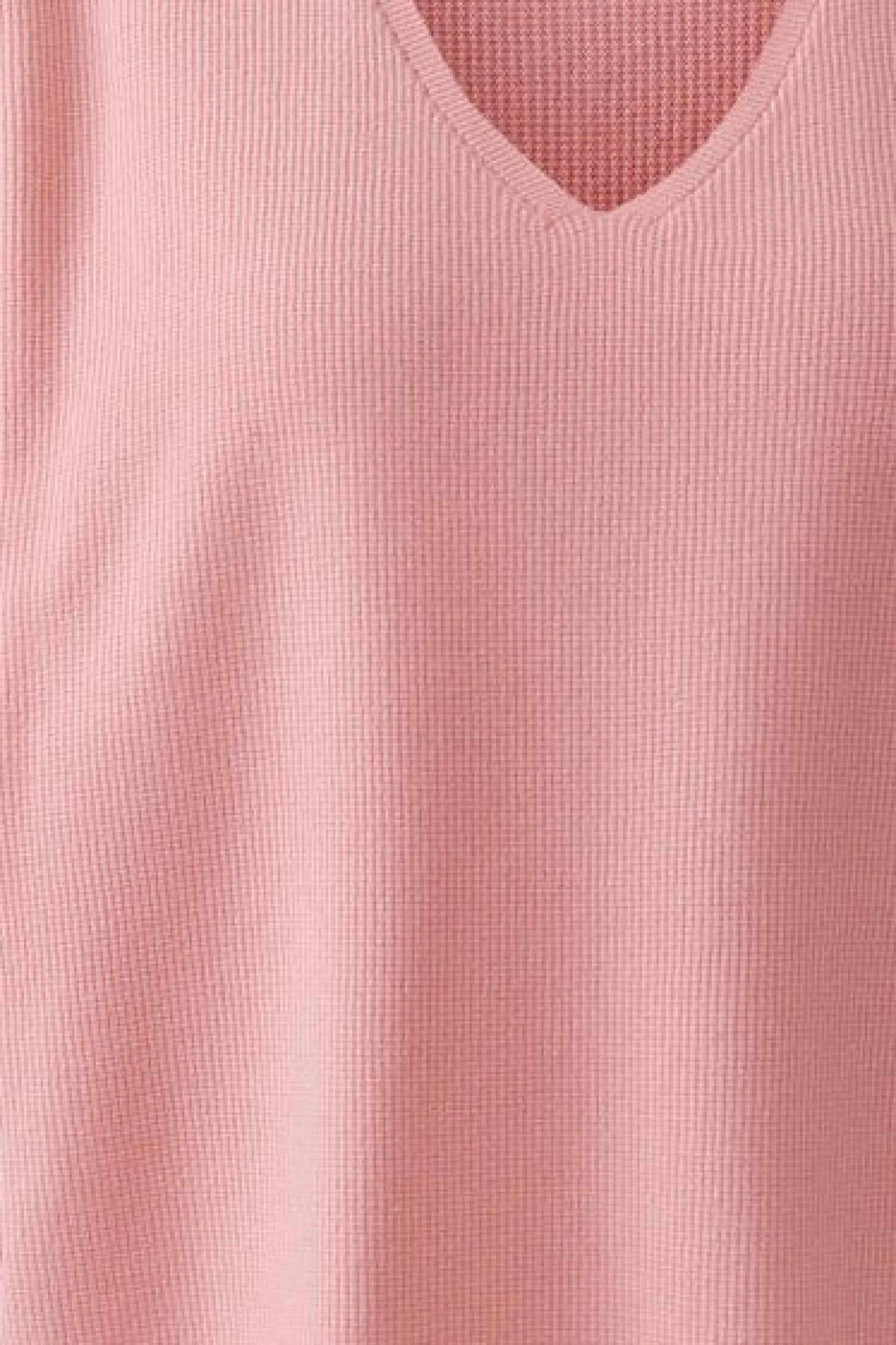 Textured pink pullover with a V-neck, showcasing a simple and casual style.