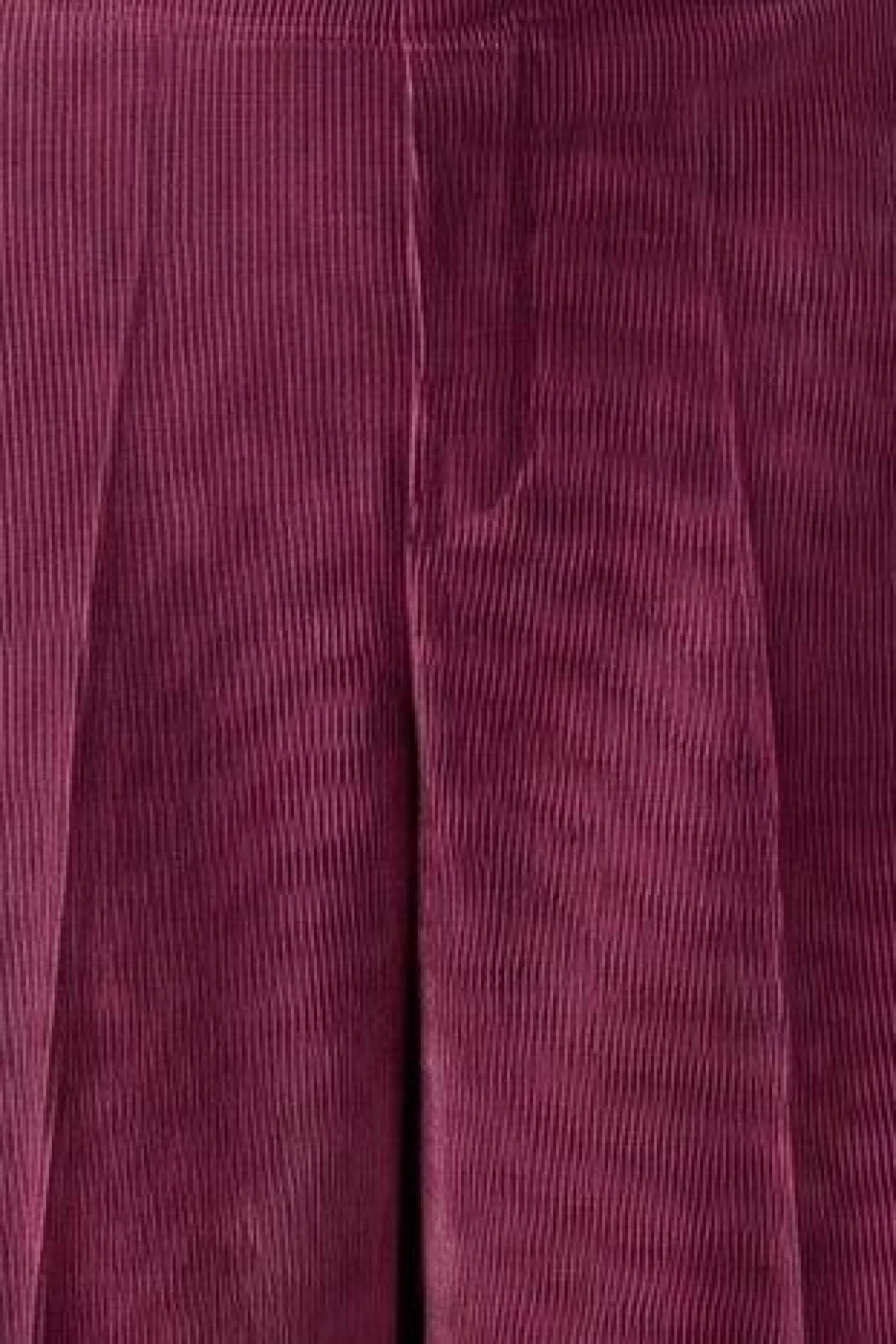 Women's corduroy pants in rich burgundy, showcasing a textured, casual style.