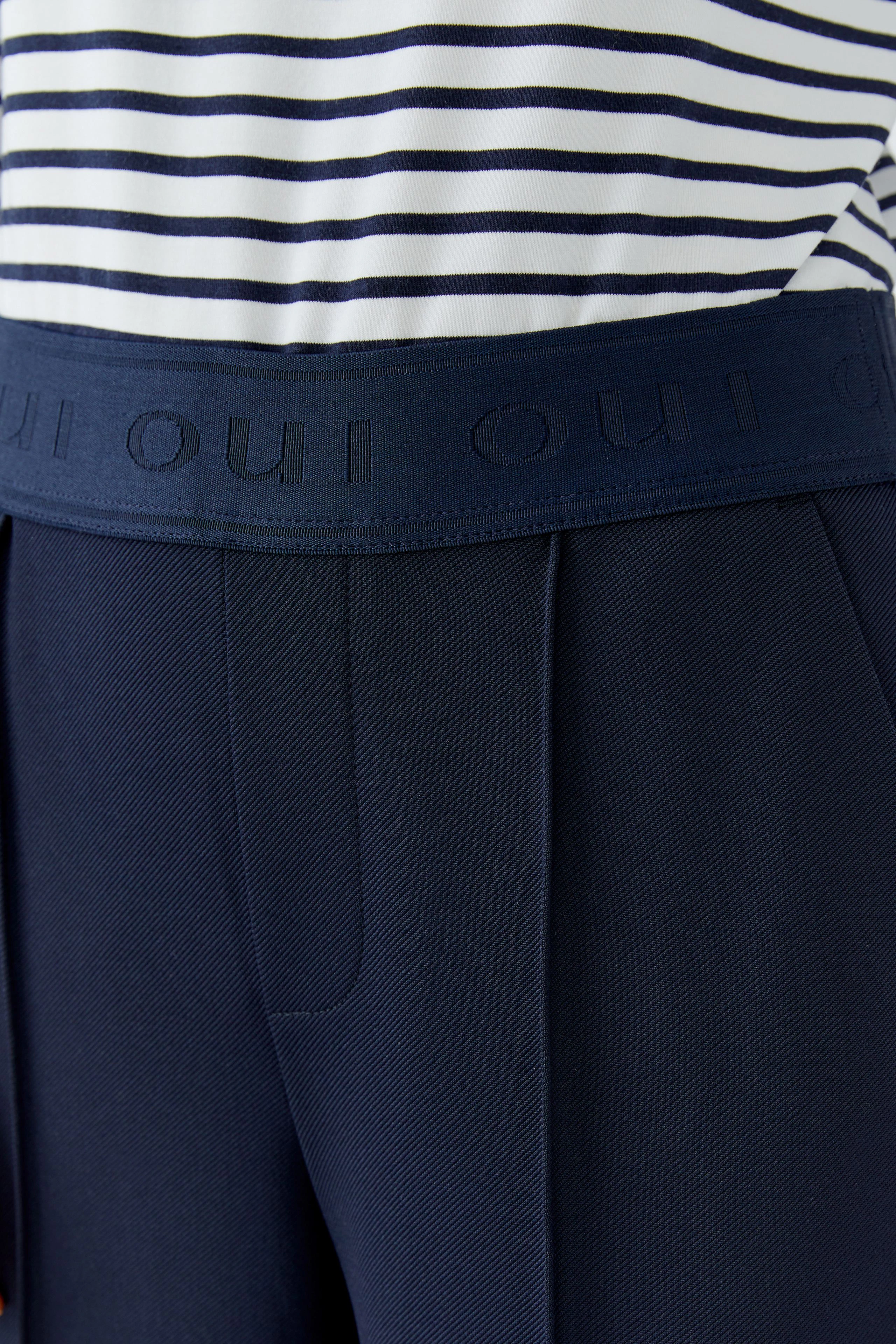 Comfortable women's trousers with a wide waistband and side pockets, perfect for casual wear.