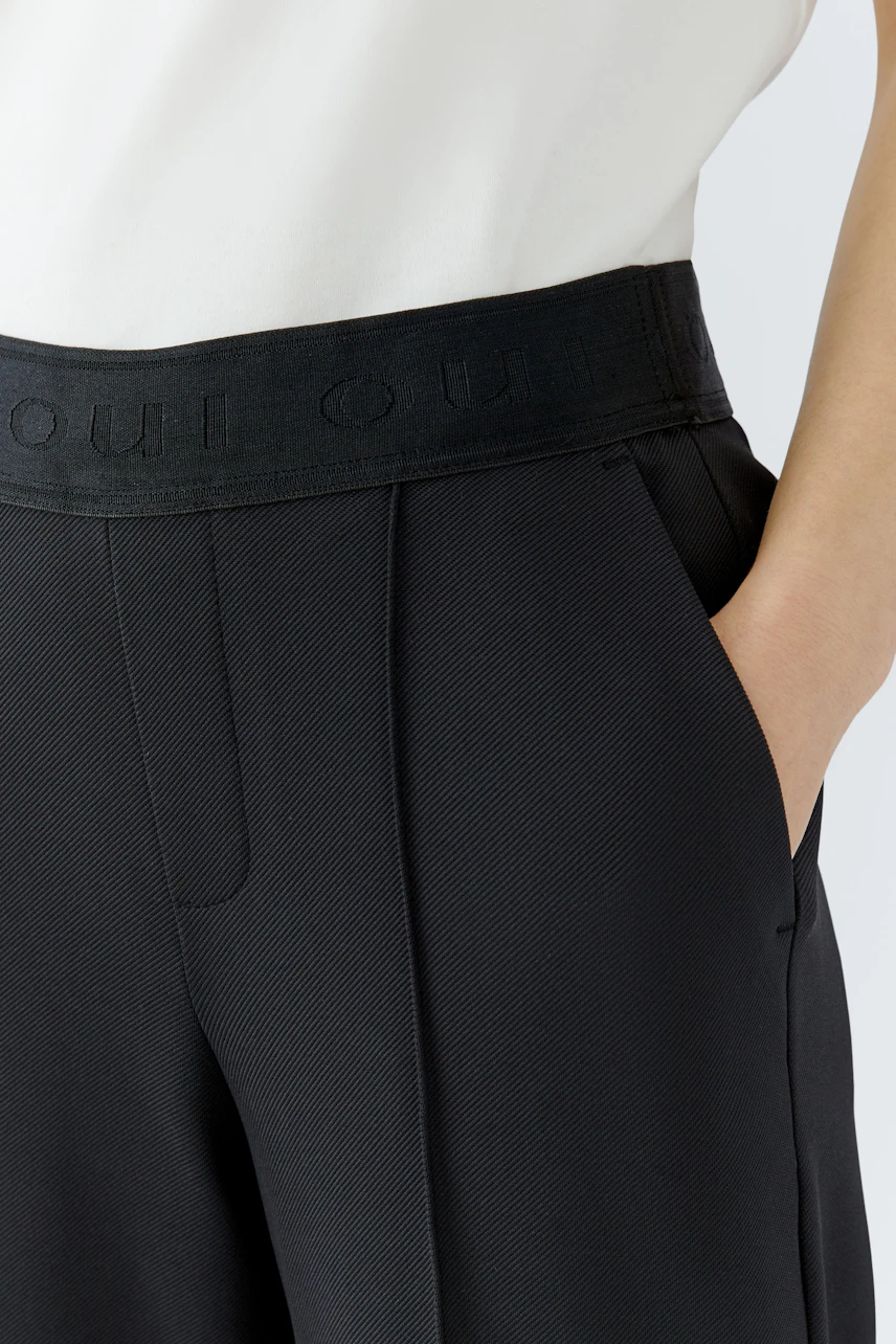 Comfortable women's trousers with a wide waistband and pockets, perfect for casual wear.