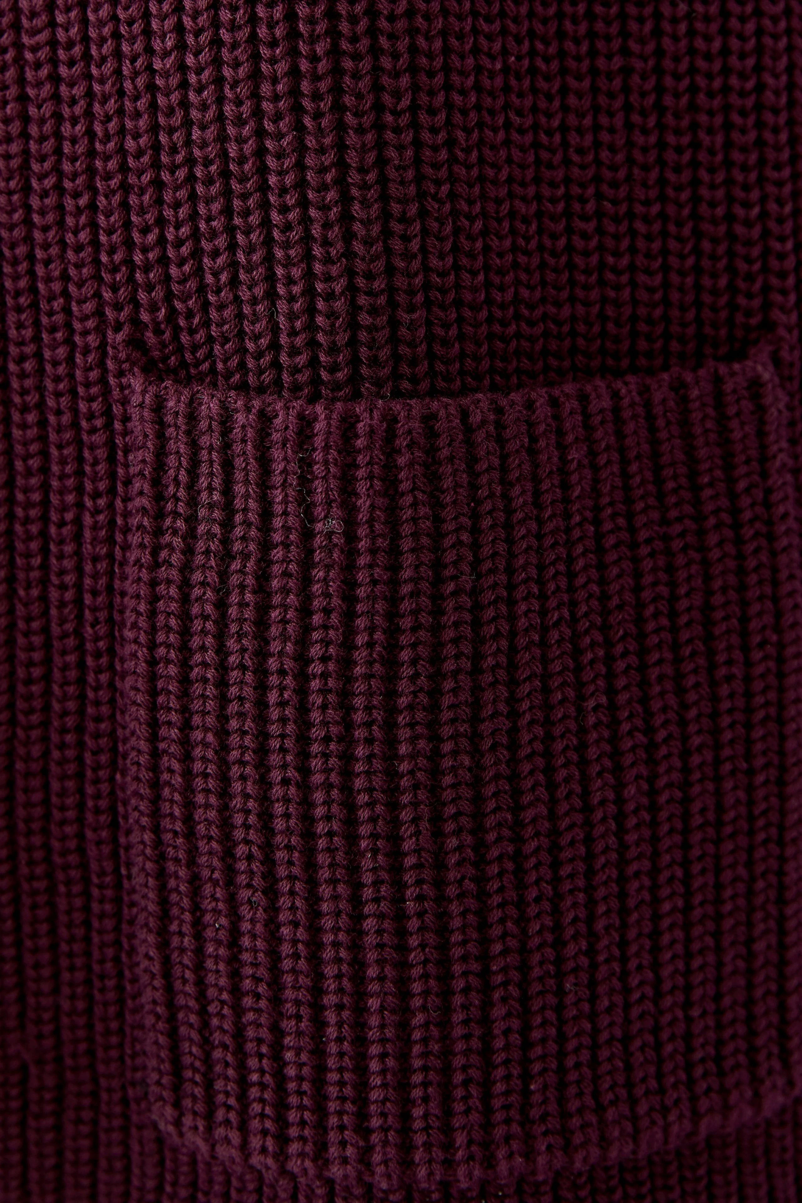 Cozy knit pullover in deep burgundy with a textured pocket detail, perfect for casual wear.